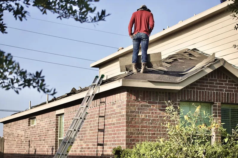 Professional roofer working on a residential roof in Barksdale Estates